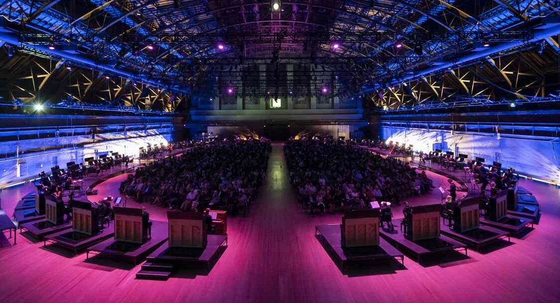 11,000 Strings Tuned Slightly Differently Makes Music to Engulf an Audience Encircled by 50 Pianos (Video)