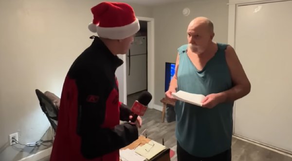 Veteran Using A Cardboard Box As A Table Gets Surprised By A Secret Santa